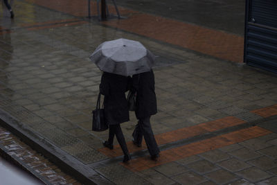 Low section of man walking on footpath