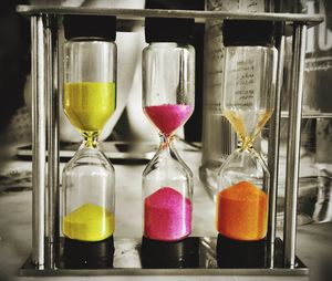 Close up view of hourglasses with multi colored sand