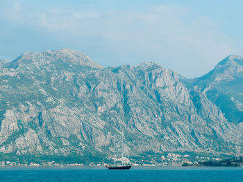 Scenic view of sea and snowcapped mountains against sky