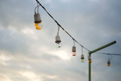 Low angle view of lantern hanging against sky