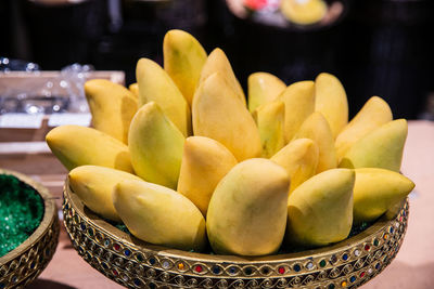 Close-up of fruits in basket on table
