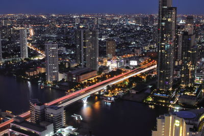 High angle view of illuminated buildings in city at night