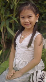 Portrait of smiling girl standing outdoors