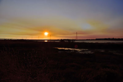 Scenic view of silhouette land against sky during sunset