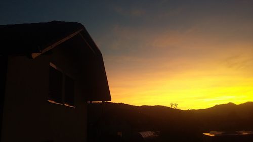 Low angle view of silhouette building against sky