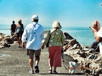 Rear view of people on beach