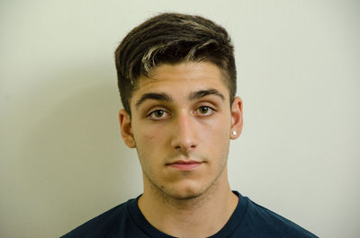 Portrait of young man against white background