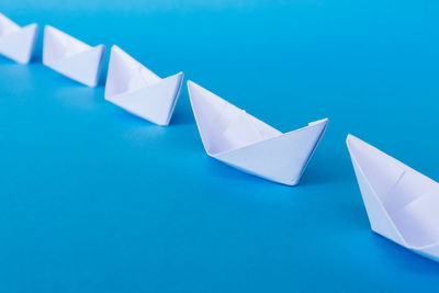 High angle view of paper on table against blue background