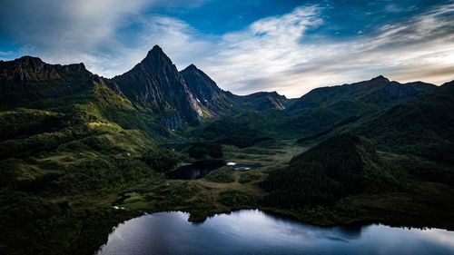 Scenic view of lake and mountains against sky