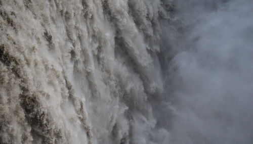 Full frame shot of waterfall against sky