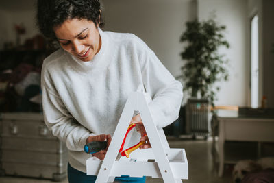 Man holding paper while standing on table at home