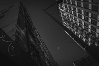 Low angle view of buildings against sky at night