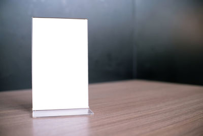 Close-up of white table against the wall