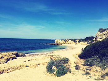 Scenic view of sea against blue sky