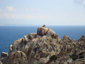 Scenic view of sea and rocks against sky