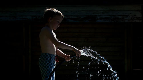 Side view of girl standing in water