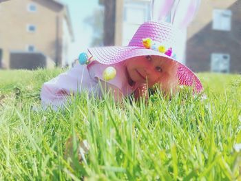 Portrait of playful girl on grassy field during sunny day