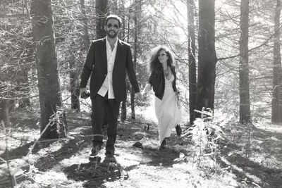 Full length of woman standing in forest