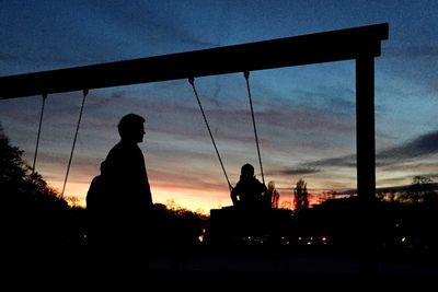 Low angle view of silhouette built structure against sky at dusk