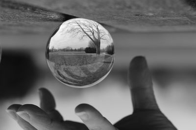 Reflection of person hand on glass