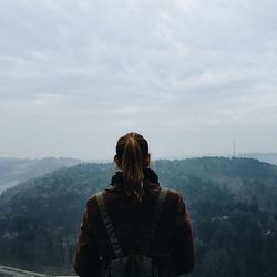 Rear view of female hiker looking at mountain