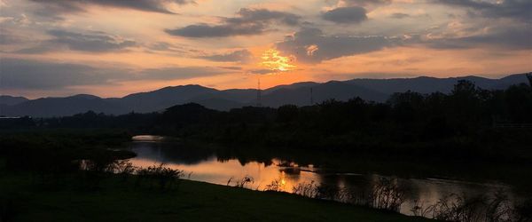 Scenic view of lake against sky during sunset