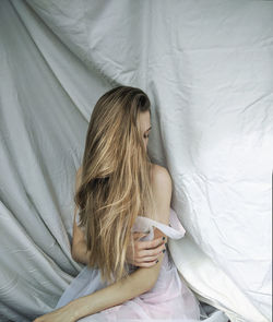 High angle view of woman lying on bed