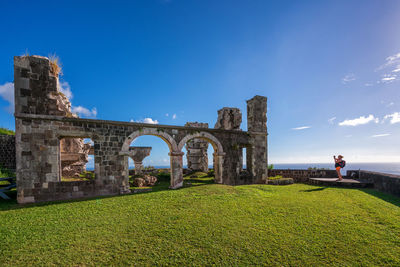 Old ruin building against blue sky