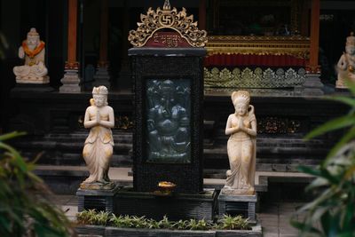 Statue outside temple against building