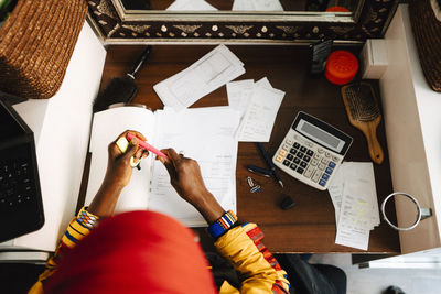 Directly above shot of female barber at table in hair salon