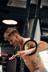 Side view of man exercising in gym