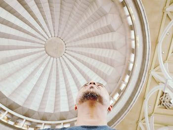 Directly below shot of man against ceiling