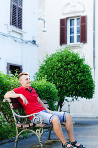 Young happy handsome bearded man, tourist walking in old city of koper. summer vacation. sunglasses.