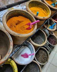 High angle view of various curry powder and spices displayed for sale