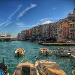 Boats in canal with buildings in background