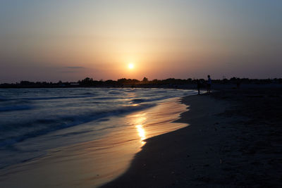 Scenic view of beach against sky during sunset