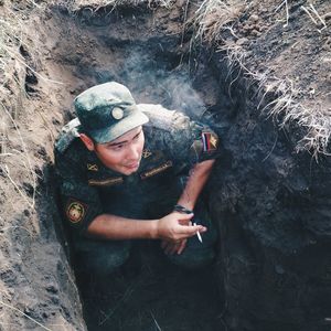 High angle view of soldier smoking cigarette