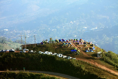 High angle view of crowd on field by mountains