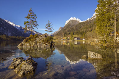 Scenic view of lake and mountains against sky