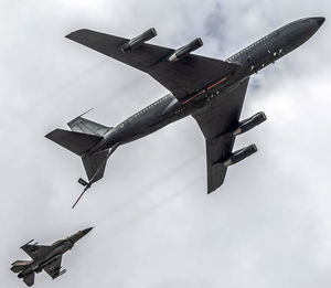 Low angle view of airplane flying against sky