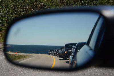 Reflection on side-view mirror of car