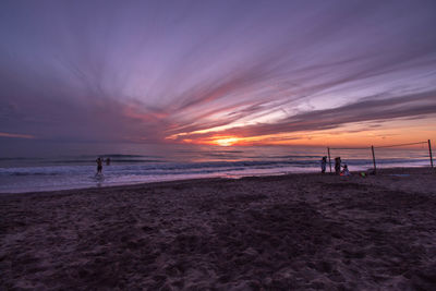 Scenic view of beach against sky during sunset