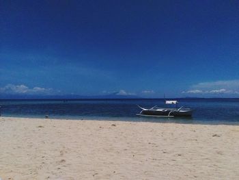 Scenic view of sea against blue sky