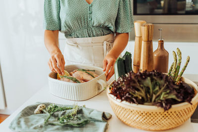 Midsection of woman preparing food at home