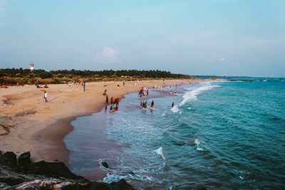 People on beach against sky