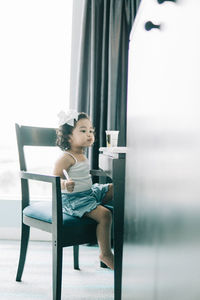 Boy sitting on table at home