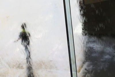 Close-up of car window against sky