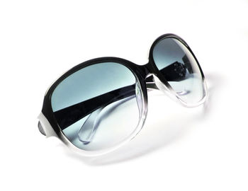 Close-up of sunglasses against white background