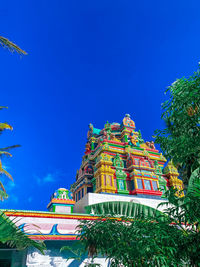 Low angle view of illuminated building against clear blue sky