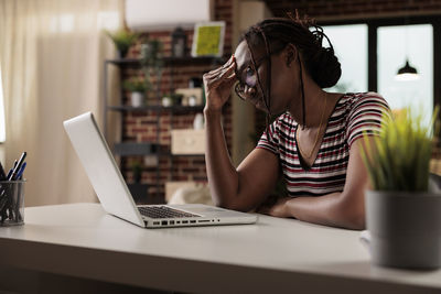 Businesswoman using laptop on table